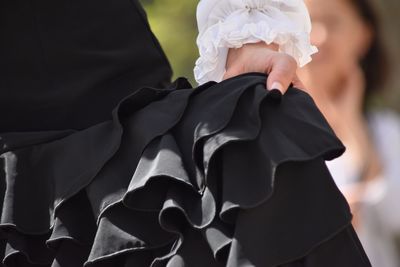 Midsection of flamenco dancer holding black dress