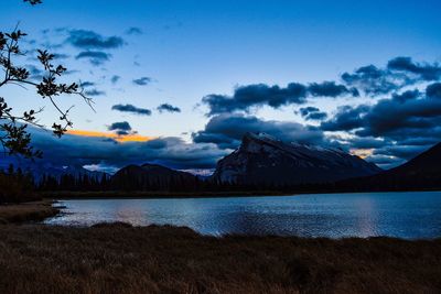 Calm lake against mountain range
