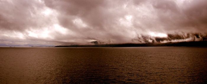 Scenic view of sea against cloudy sky