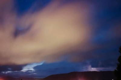 Low angle view of dramatic sky at night