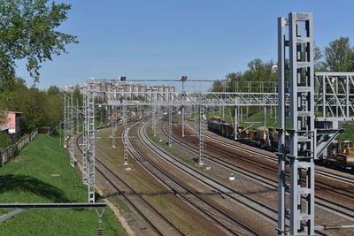 Railroad tracks in city against clear sky