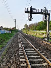 Railroad track amidst trees against clear sky