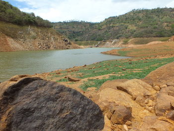 Scenic view of river amidst mountains against sky