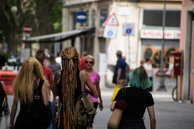 Rear view of people walking on street