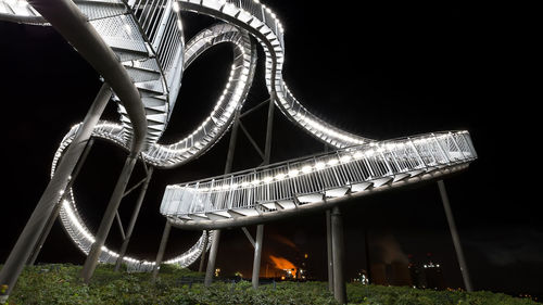 Low angle view of illuminated ferris wheel at night