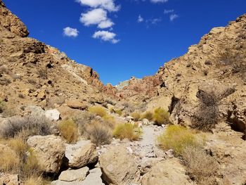 Scenic view of rocky mountains against blue sky