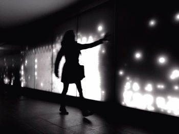Full length of woman in illuminated room