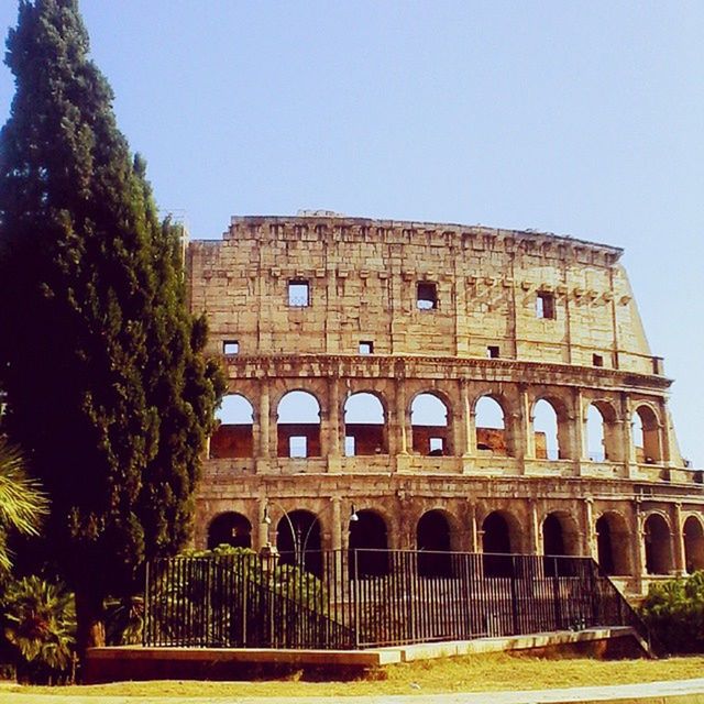 architecture, built structure, arch, building exterior, clear sky, history, travel destinations, low angle view, tourism, travel, tree, famous place, day, incidental people, arched, old, the past, ancient, outdoors, copy space