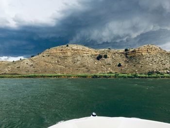 Scenic view of lake against cloudy sky