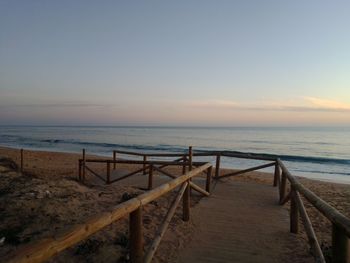 Scenic view of beach against sky during sunset