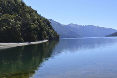 Scenic view of lake and mountains against clear sky