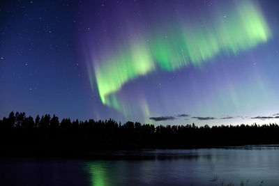 Scenic view of lake against sky at night