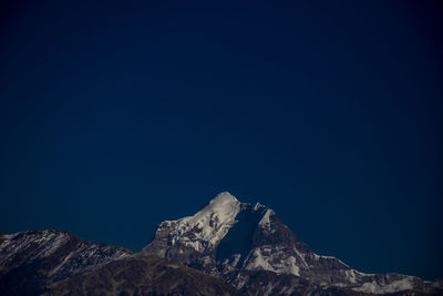 Scenic view of mountains against blue sky