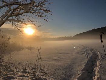 Scenic view of lake against sky during winter