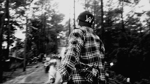 Woman standing by trees in forest