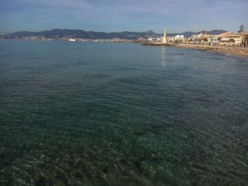 Scenic view of sea and buildings against sky