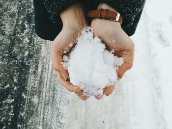 Close-up of person holding snow