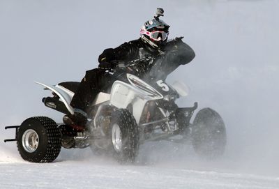 People riding motorcycle on snow