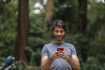 Portrait of young man sitting outdoors