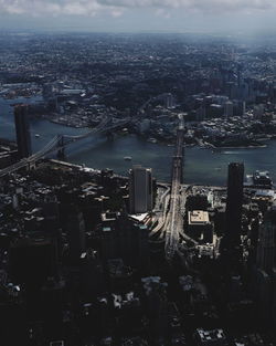 High angle view of illuminated city by buildings against sky