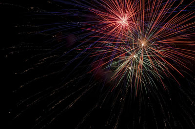 Low angle view of firework display at night