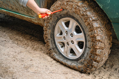 Person trying to repair flat tire