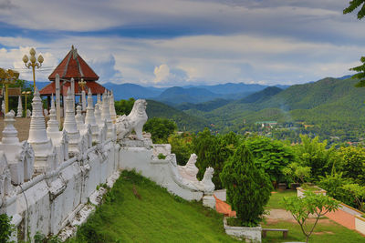 Panoramic view of temple and buildings against sky