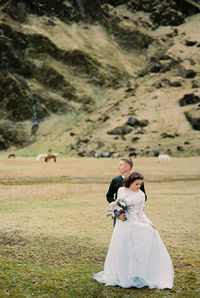 Bride standing on field