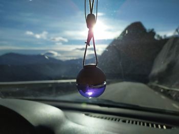 Close-up of light bulb against sky