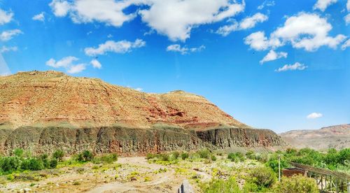 Scenic view of rocky mountains against blue sky