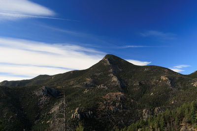 Scenic view of mountains against blue sky