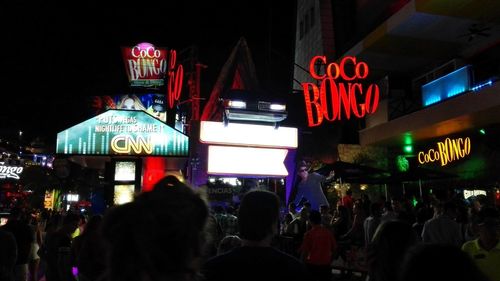 Crowd in illuminated city at night