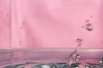 Close-up of water falling from pink splashing