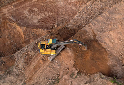 High angle view of road sign on rock