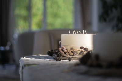 Pine cones with candle on table