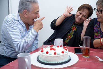 Portrait of friends sitting on table