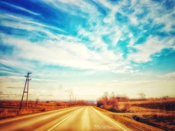 Country road against sky