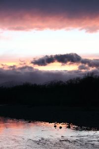 Scenic view of lake at sunset