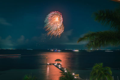 Scenic view of lake against sky at night