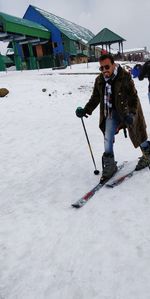 Full length of man skateboarding on field during winter