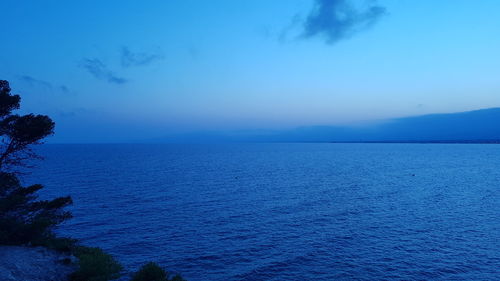 Scenic view of sea against blue sky