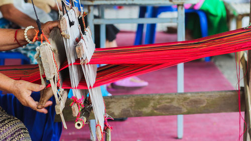 Close-up of woman holding threads