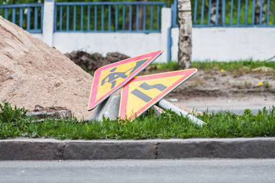 Close-up of yellow flag on road in city