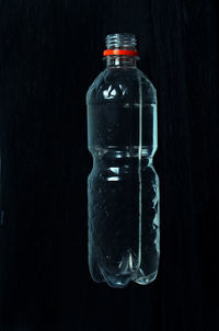 Close-up of bottle against black background