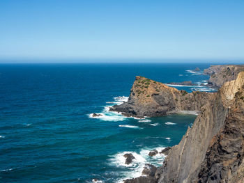 Scenic view of sea against clear blue sky