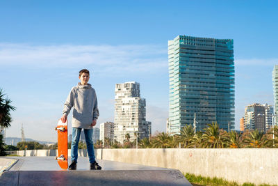 Young skater teen standing on ramp ready to start riding