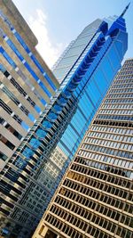 Low angle view of modern building against blue sky