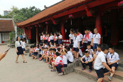 Group of people in temple outside building