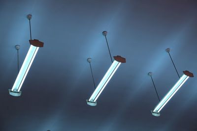 Low angle view of illuminated lights hanging from ceiling