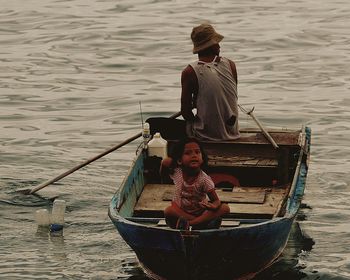 People fishing in boat on lake